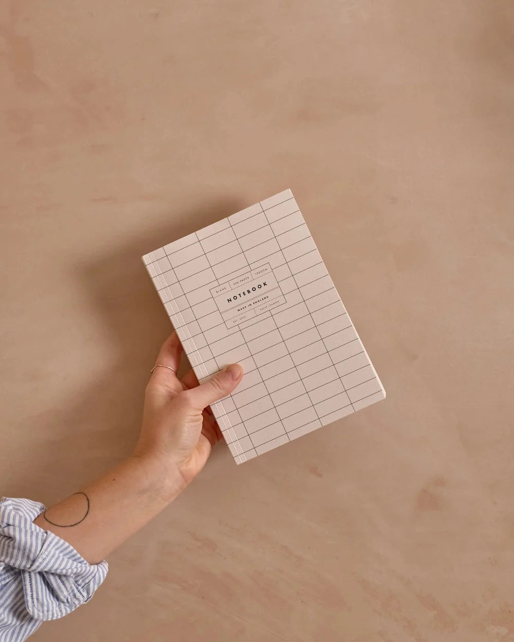 katie leamon holding her ivory grid lay flat notebook