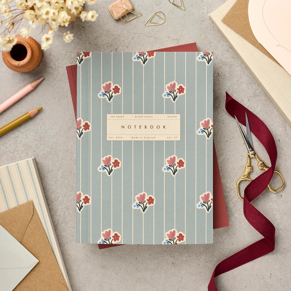 Katie Leamon Vol.57 A5 lay-flat notebook with Wallpaper Posy cover Ñ blue-grey stripe and scattered pink and red floral clusters, 300 blank ivory pages